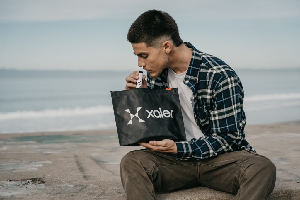 happy xaler customer with a bag of xaler cannabis products